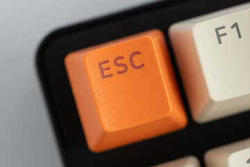 Closeup orange esc button on computer keyboard.