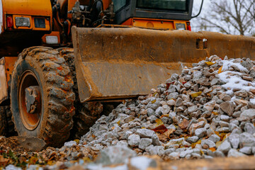 Modern excavator with a blade at a construction site on an overcast day. High quality photo