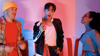 Asian break dancer perform freestyle movement and jumping at party with pink led or neon light....