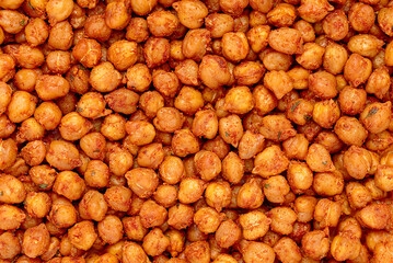 Macro photography of roasted crispy chickpeas with paprika, chili and herbs, healthy vegan food, natural plant based protein, healthy nutrition, dietary fibre
