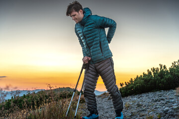 Travelling Man Holds His Lower Back with an Expression of Pain on His Face