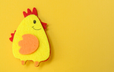 Easter one chicken handmade on yellow background, DIY concept, copy space, flat lay, easter concept