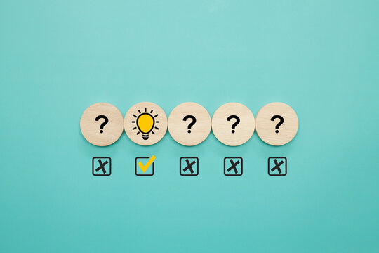 Idea,creative, creative thinking, problem solving, innovation. Bright light bulb symbol which among question icon while at the table in the office