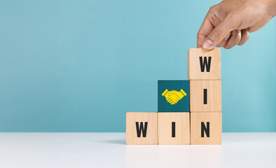 Win to win, strategy, business,success, deal. Hand of person holding wooden cube With WIN and WIN word Indicates business deal