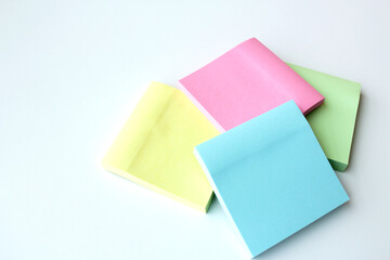 Sticky notes in four pastel colors. Stationery post for office, school, home and self reminder. Square adhesive paper pads.