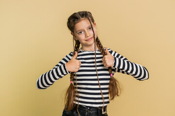 Like. Happy young preteen child girl kid looking approvingly at camera showing thumbs up, like sign...