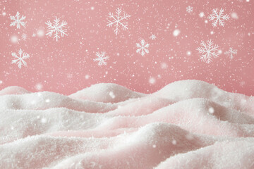 Obraz premium Snow-covered hills on a pink background with falling snowflakes.
