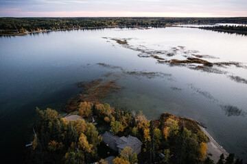 A lake with a house on the shore