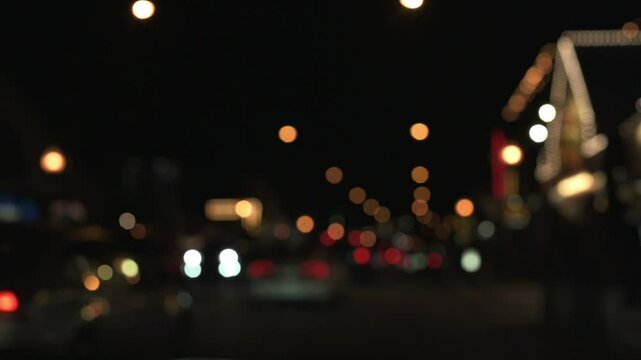 Abstract bokeh of city street lights at night, creating dreamy and vibrant urban atmosphere with cars and illuminated buildings in soft focus. blurred night city street lights street lights at night