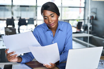 Busy African American business woman executive manager working in office checking legal document...