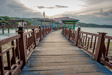 Baubau, Indonesia, March 24 2024 - Titian Bridge, Wooden Pier at Batusori Tourist Attraction When Tranquility Meets Nature