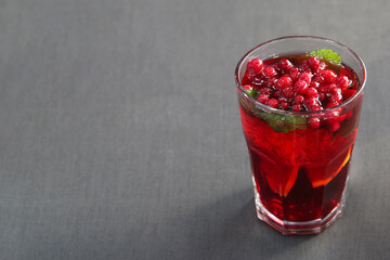 Berry cranberry tea with mint in a glass glass