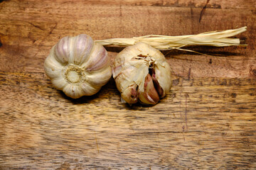 Organic garlic laid on a wooden countertop. Garlic is an excellent natural antibiotic and has many health properties. It is also a great condiment