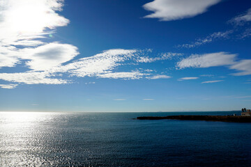 Endless spaces. Streams of light and waves of water. Sea, horizon, clouds. Beautiful view. November.