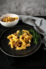 Italian pasta with chicken in a bowl. on a black background. lunch .italy