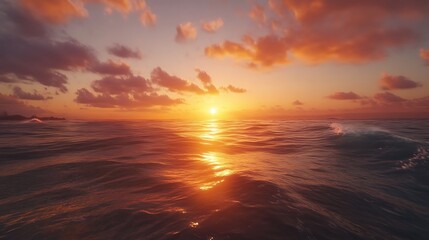 Obraz premium A serene sunset over calm ocean waters, reflecting warm hues and gentle waves.