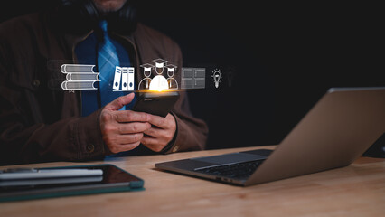 Professional utilizing smartphone, surrounded by educational icons, representing integration of technology in learning and pursuit of innovation in modern workspace