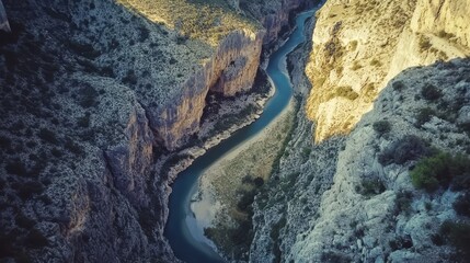 Aerial shot of a winding river cutting through a lush green landscape

