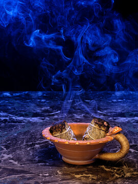 Smudging sage stick burning in moonlight