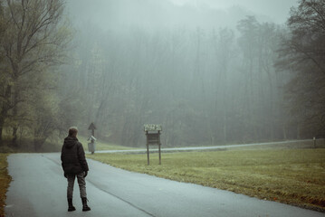 girl in a gloomy autumn forest in the mountains with fog