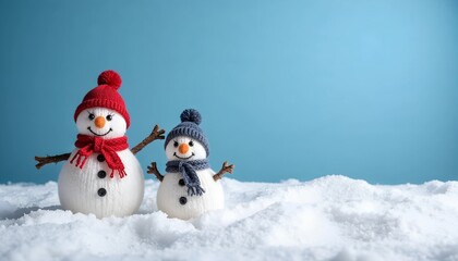 Adorable snowman family wearing hats and scarves standing in snow against blue background