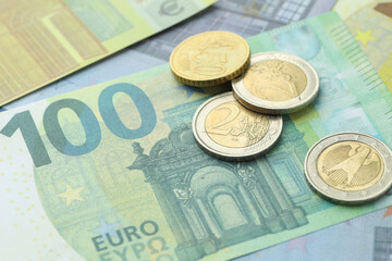 Different coins on euro banknotes, closeup view