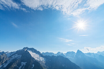 Clear blue sky over snowcapped peaks