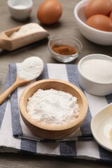 Baking powder in bowl and other products on wooden table