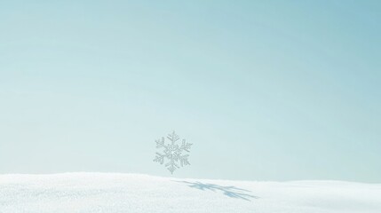 Fototapeta premium A minimalist scene of a single snowflake falling, set against a pale blue sky