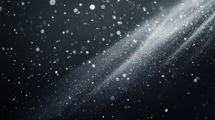 Wisps of white dust spreading gently through the air, highlighted by soft light