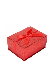 A red gift box with a ribbon, isolated on a white background, emphasizing its festive and elegant appearance