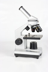 A microscope isolated on a white background, showcasing its clean design and scientific precision