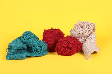 A group of yarn balls in various colors arranged on a colorful background, showcasing a vibrant and creative knitting setup
