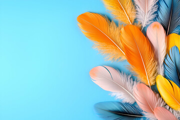 Naklejka premium Vibrant feathers in various colors arranged artistically against a blue background, creating a lively and playful visual effect.