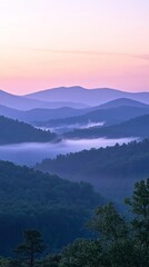 Obraz premium Serene Mountain Sunrise, tranquil peaks enveloped in mist, soft pastel hues illuminating the sky, a peaceful dawn in nature's embrace, inviting reflection and calmness.