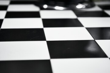 Black and white checkerboard pattern displayed on a polished surface