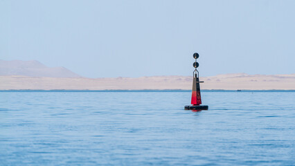 A channel beacon floating in the ocean.