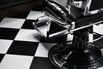 Classic barber chair on a black and white checkered floor