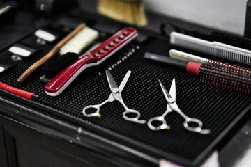 Tools for grooming prepared on a work surface in a barbershop setting