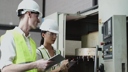 A young white male engineer advice the data to Asian female compare data in the digital tablet lwith cnc machine in the factory. - Powered by Adobe