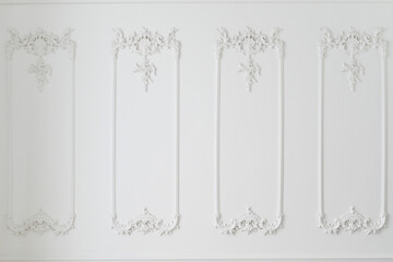 Elegant white wall with ornate decorative moldings