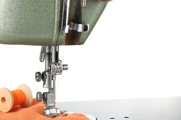 Sewing machine with orange fabric and spool of thread isolated on white