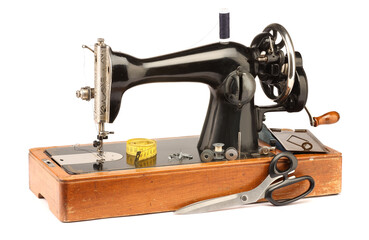 Sewing machine with measuring tape, scissors and spools of threads isolated on white