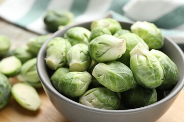 Fresh green Brussels sprouts in bowl on table, closeup