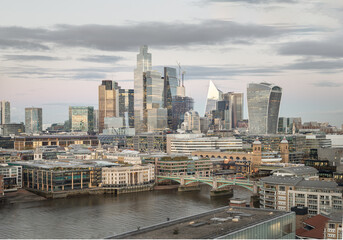 Naklejka premium Evening time scene with bright glowing lights of various skyscrapers at London city.