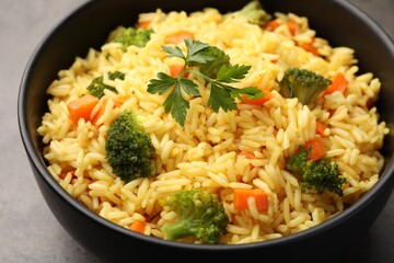 Tasty rice with vegetables on grey table, closeup