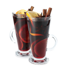 Tasty mulled wine with orange and spices isolated on white. Christmas drink