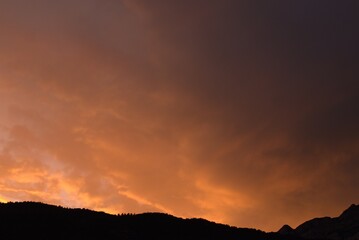 Mountains at sunset with a heavy cloudy sky, Trentino Alto Adige, Italy