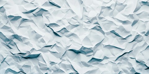 Fototapeta premium A close-up view of crumpled light blue paper, showcasing intricate textures and folds.