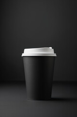 Black coffee cup mockup with a white lid on a dark background